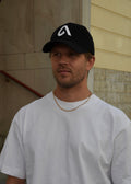 Black corduroy unisex cap with embroidery, structured front and adjustable metal buckle strap