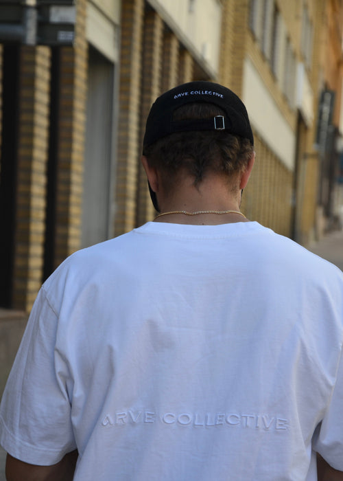 Black corduroy unisex cap with embroidery, structured front and adjustable metal buckle strap