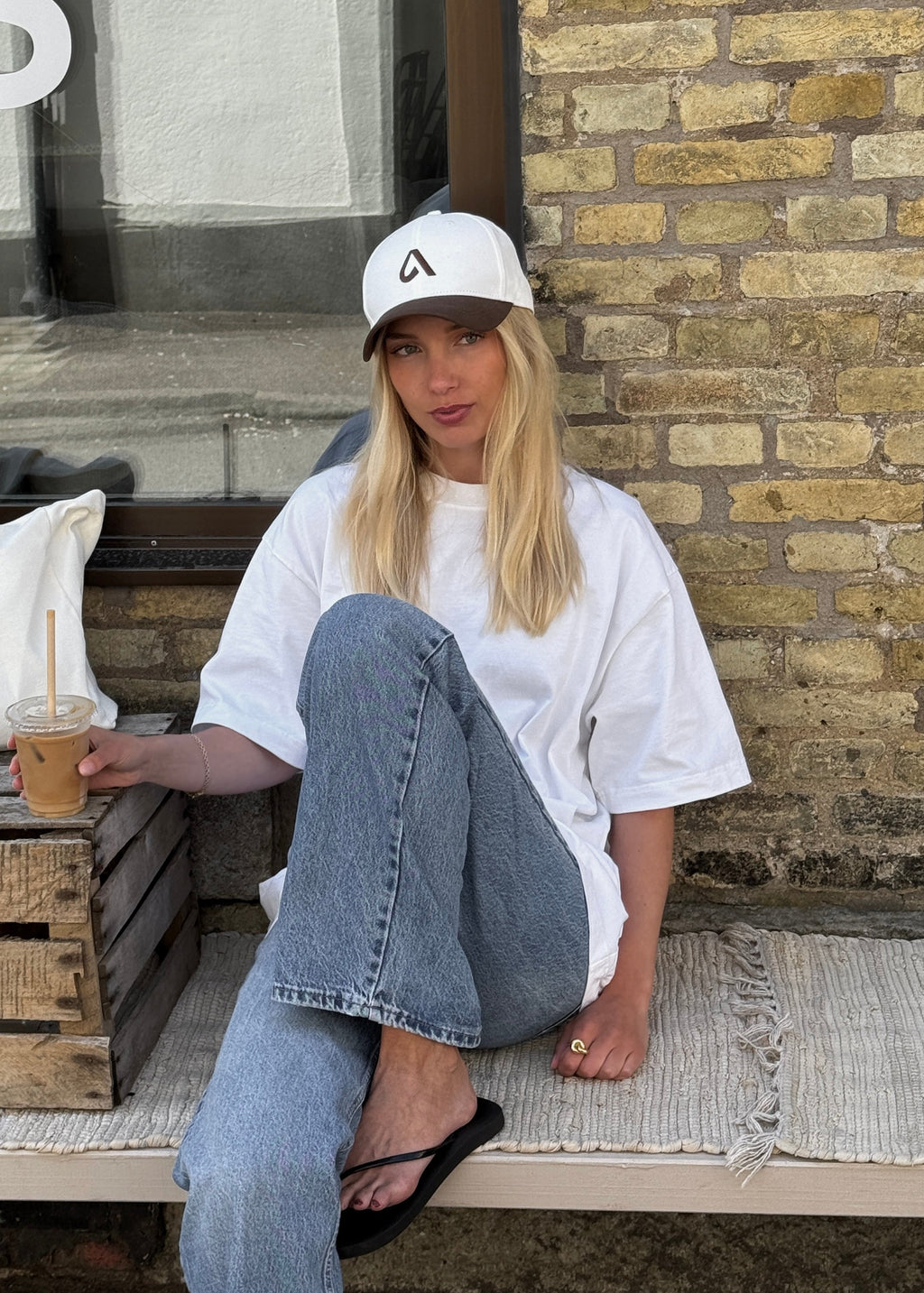 Brown and white unisex cap with embroidery, structured front and adjustable metal buckle strap by Arve Collective