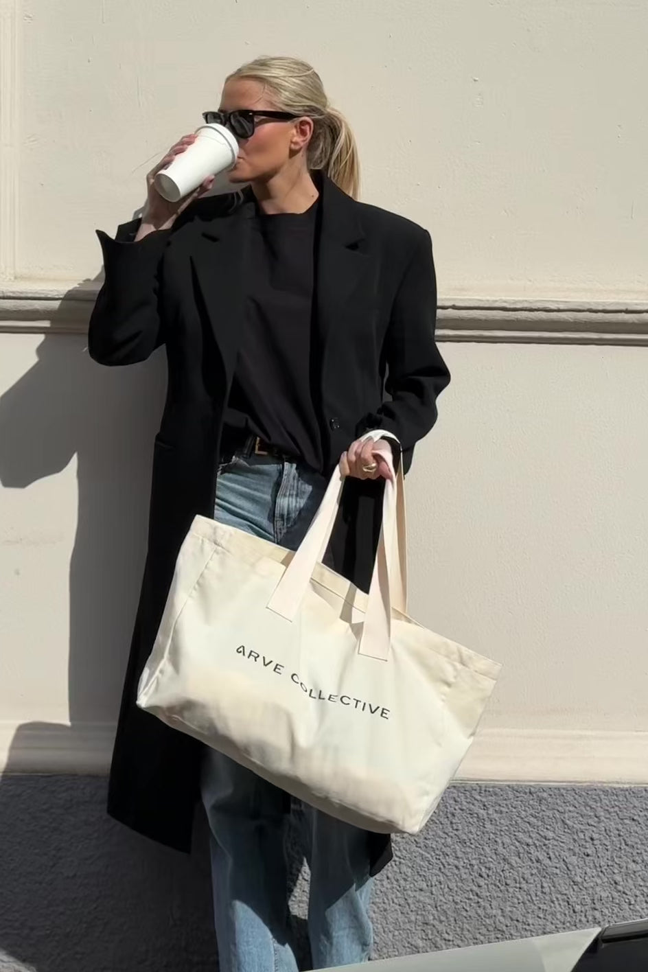 Large canvas bag with minimalistic, structured silhouette and logo print by Arve Collective
